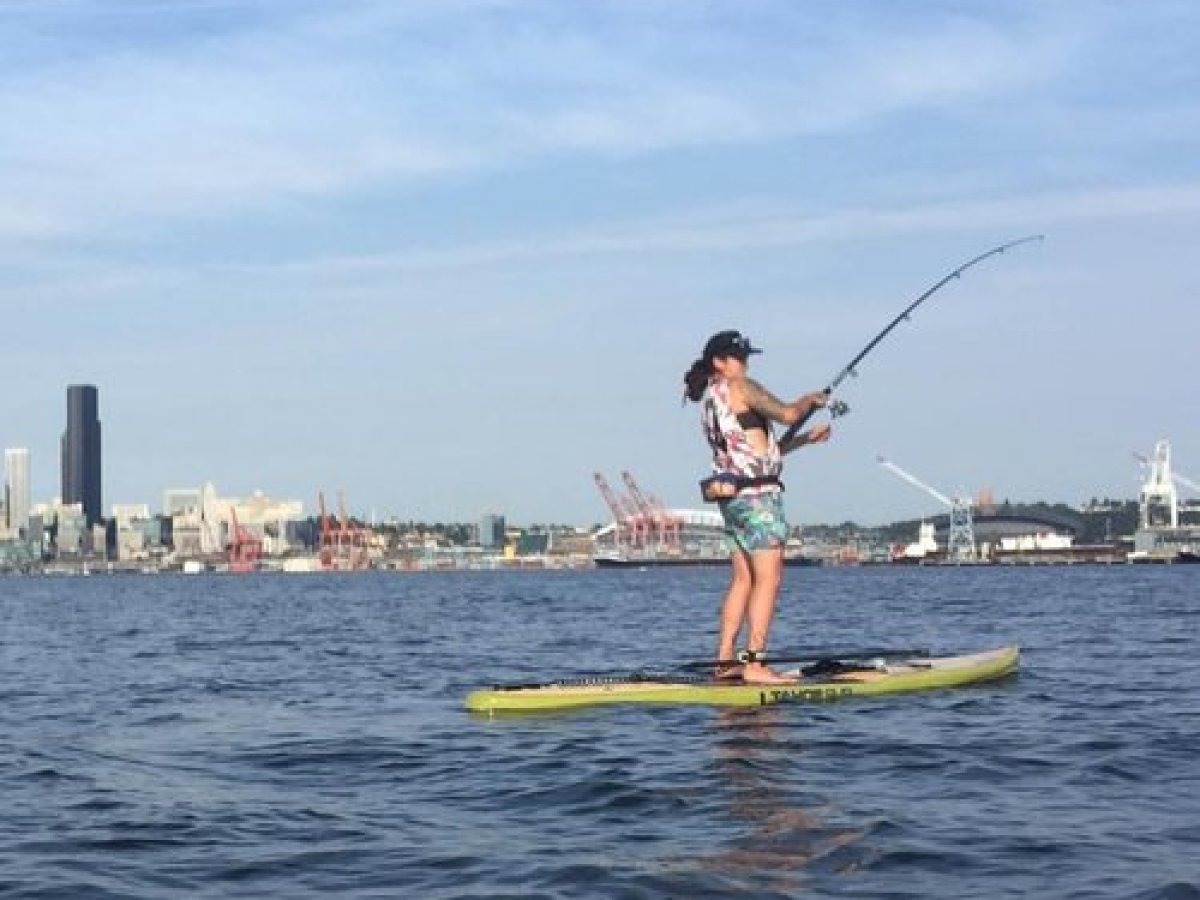 Woman fishing from paddlebaord