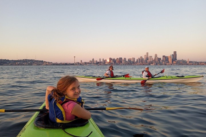 a small child sitting on a boat in the water