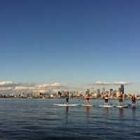Paddle boarders with Seattle in the background